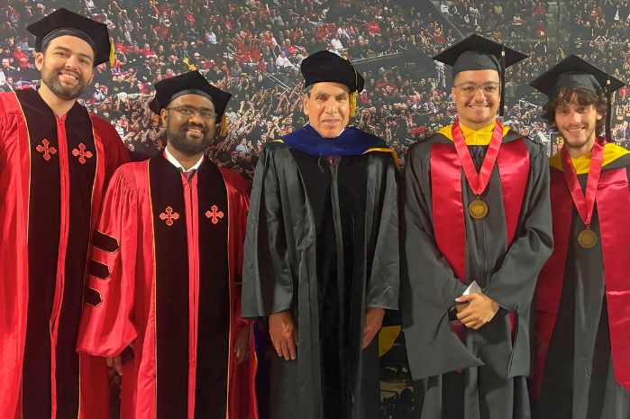 CEEE graduates at Clark School 2026 Commencement at the Xfinity center. Graduates and faculty are dressed in academic regalia.