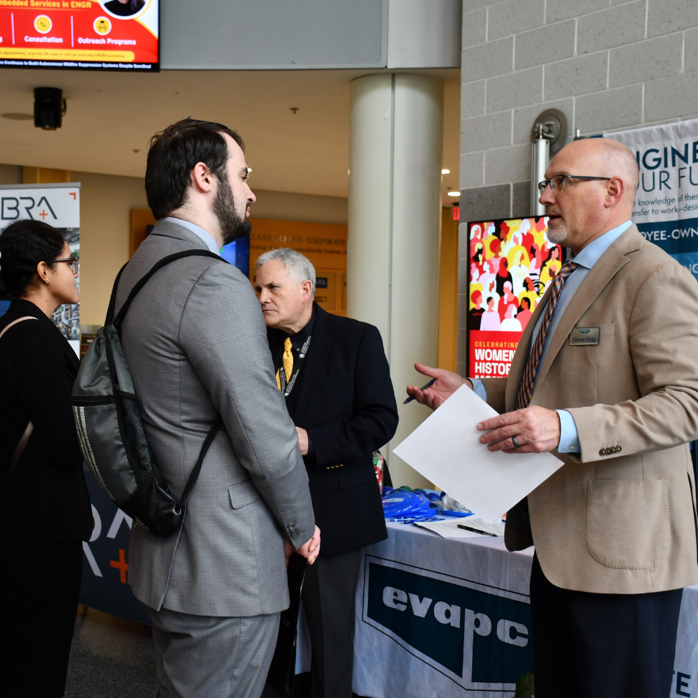 Employers chat with students at the career fair in the Kim Engineering Building Rotunda
