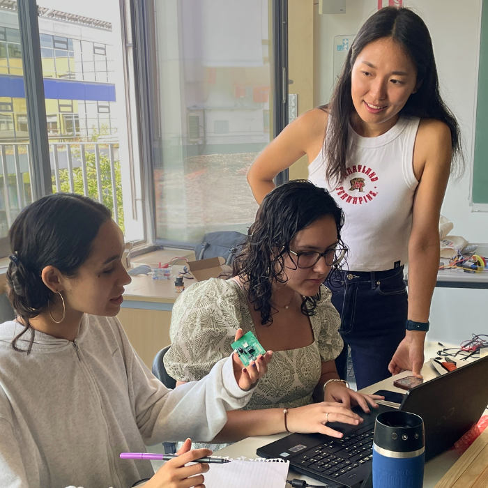Dana Kang helps two students from the German International School Washington D.C.