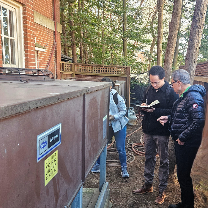 CEEE team inspects outdoor HVAC unit at Government House