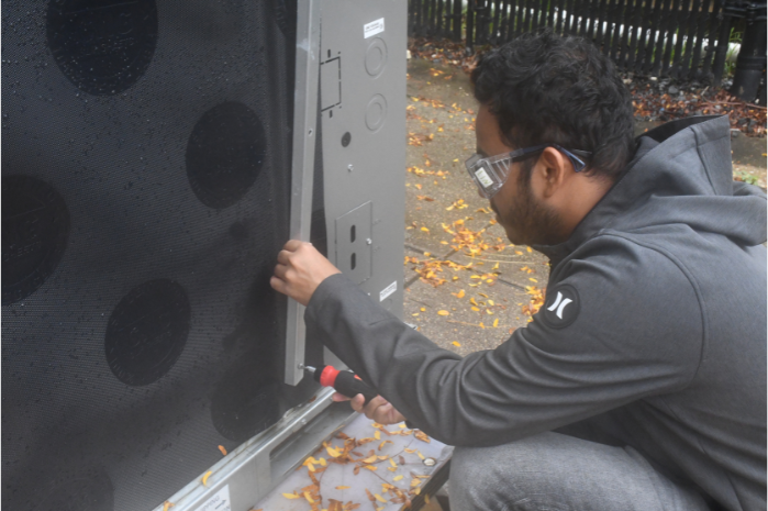 student working on cold-climate heat pump