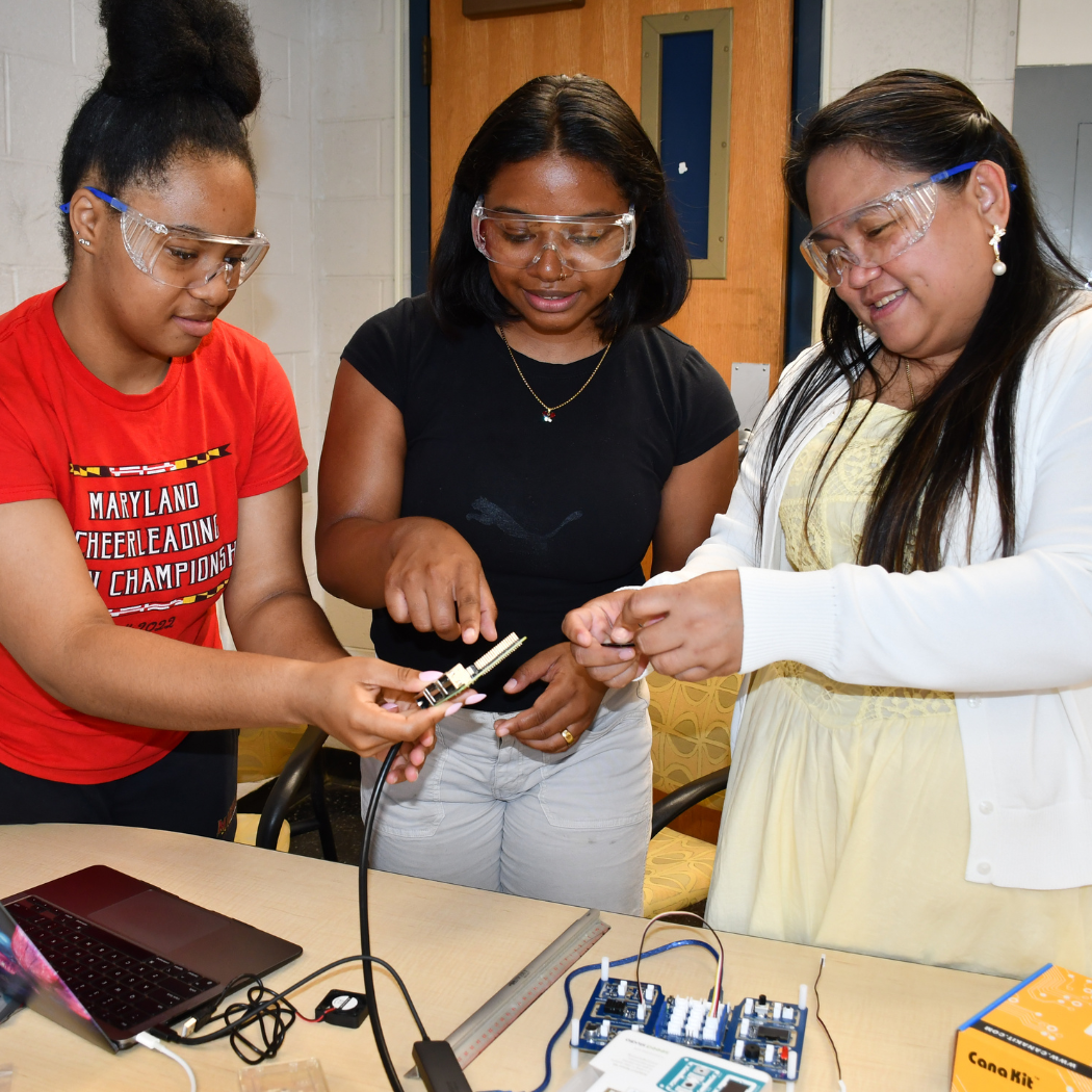 UMD students help an RET teacher with the Raspberry Pi configuration needed for a data center cooling experiment.