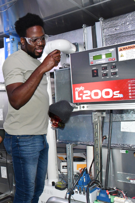 researcher working on heat pump control box